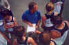 Coach Pattock has a pre-meet discussion with members of the team.